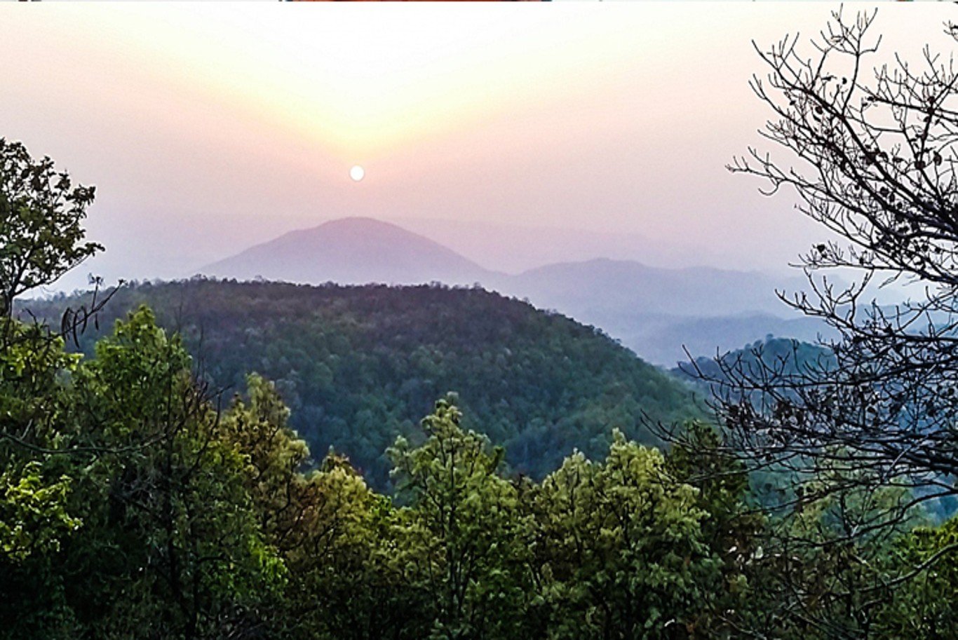 Netarhat Sunrise Point offering breathtaking sunrise views over scenic hills, lush forests, and peaceful natural landscapes.